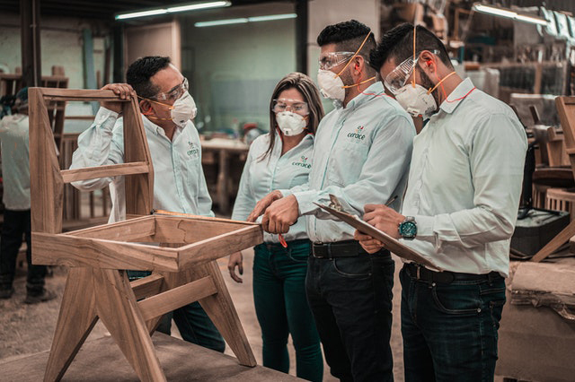 Workers wearing safey gear comply with OSHA regulations