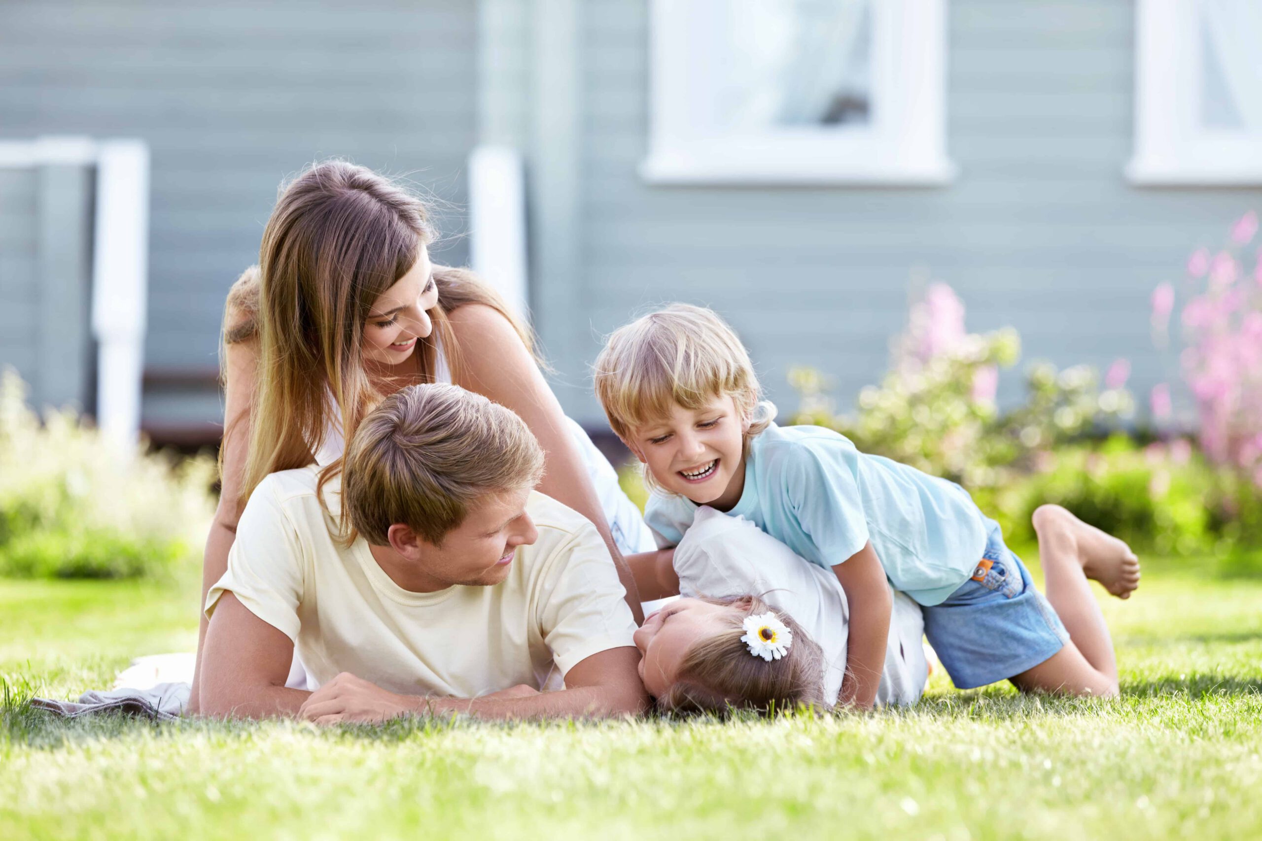 family of four smiling outside